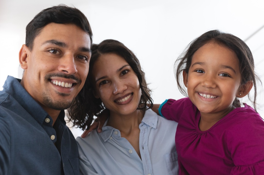 latino-couple-and-daughter-taking-selfie-smiling-to-camera-picture